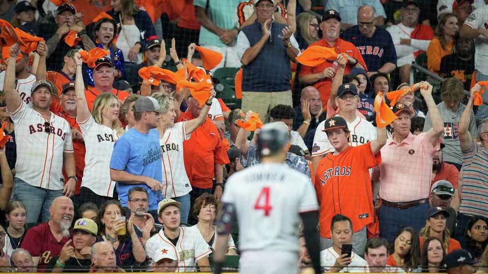 Houston Astros fans wave their towels after Minnesota Twins shortstop Carlos Correa (4) was called out on strikes to end the top of the sixth inning of game one of the American League Division Series at Minute Maid Park on Saturday, Oct. 7, 2023, in Houston.