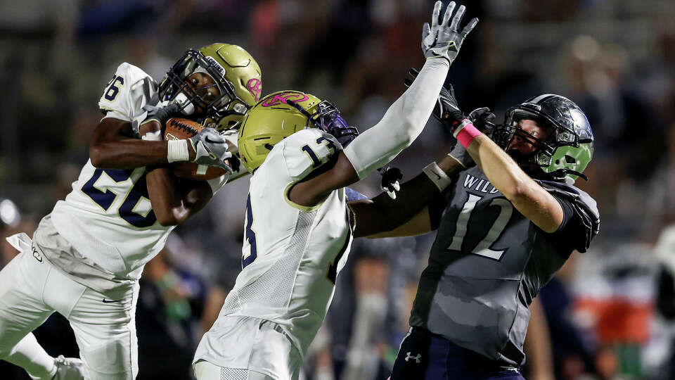 Klein Collins Tigers Tre (26) intercepts a pass intended for Tomball Memorial Wildcats quarterback Lane Stockton (12) during the high school football game between the Klein Collins Tigers and the Tomball Memorial Wildcats at Tomball ISD Stadium in Tomball, TX on Friday October 6, 2023. Klein Collins leads Tomball Memorial 35-14 in the fourth quarter.