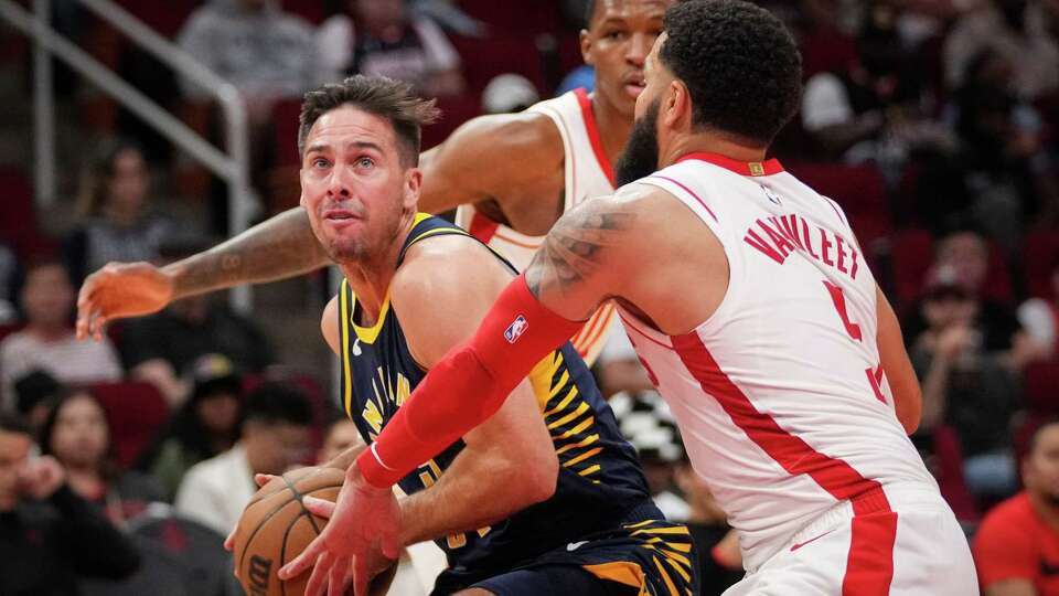 Indiana Pacers guard T.J. McConnell (9) looks towards teh basket as he runs into the defense of Houston Rockets forward Fred VanVleet (5) during the second half of a pre-season NBA game Tuesday, Oct. 10, 2023, at the Toyota Center in Houston.