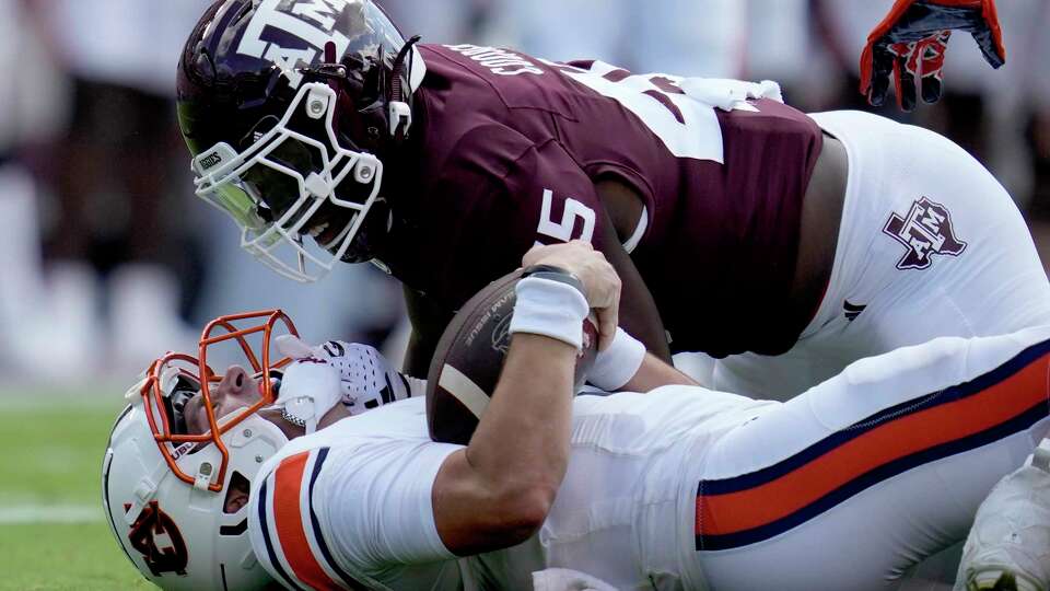 Texas A&M linebacker Edgerrin Cooper (45) gets in the face of Auburn quarterback Payton Thorne (1) after his is stopped short on a run during the first quarter of an NCAA college football game Saturday, Sept. 23, 2023, in College Station, Texas. (AP Photo/Sam Craft)