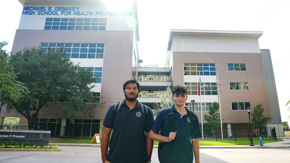 DeBakey seniors Zain Kundi, left, and Sebastian Foster stand outside their high school on Friday, Oct. 13, 2023 in Houston. The two are enrolled in AP Physics class that does not have an instructor, leaving the students to teach themselves the college-level material.