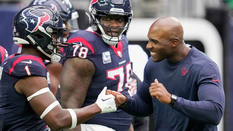 Houston Texans head coach DeMeco Ryans, right, greets safety Jimmie Ward (1) before an NFL football game Sunday, Oct. 15, 2023, in Houston.