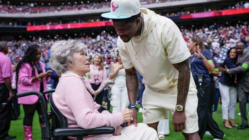 Houston Texans co-owner Janice McNair, left, visits with former Houston Texans wide receiver Andre Johnson before an NFL football game Sunday, Oct. 15, 2023, in Houston.