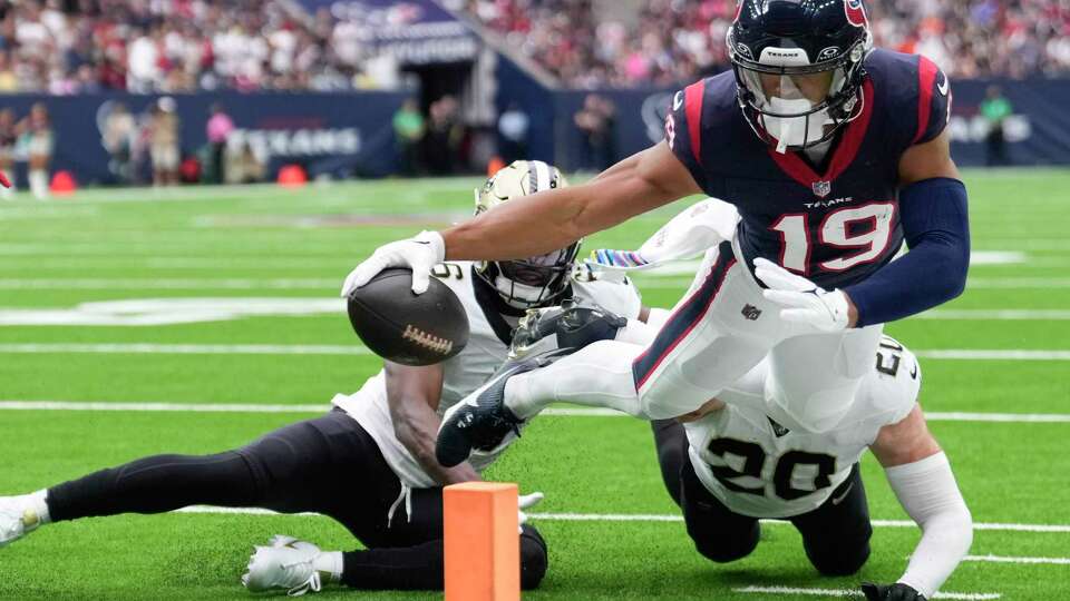 Houston Texans wide receiver Xavier Hutchinson (19) attempts to stretch the ball across the goal line during the first half an NFL football game Sunday, Oct. 15, 2023, in Houston.