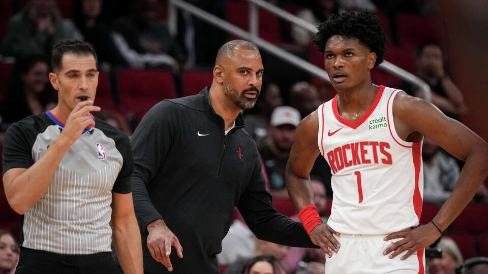 Houston Rockets head coach Ime Udoka talks with forward Amen Thompson (1) during the first half of a pre-season NBA game Tuesday, Oct. 10, 2023, at the Toyota Center in Houston.