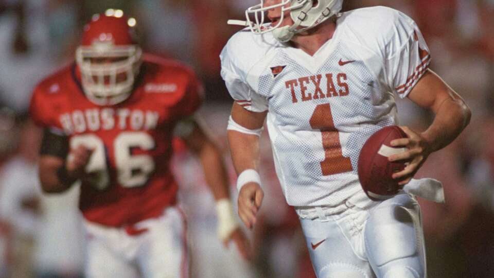 Texas' Chris Simms (1) rolls out to avoid Houston defenders during the first half of play Saturday, Sept. 22, 2001, in Houston. CHRISTOBAL PEREZ/HOUSTON CHRONICLE