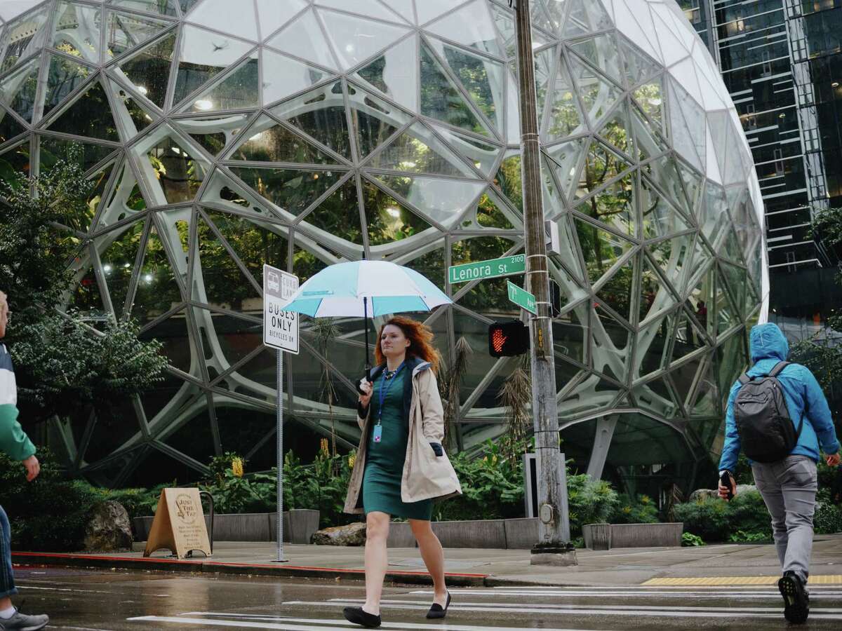 Amazon employees commute in front of the Spheres in Seattle’s South Lake Union neighborhood.