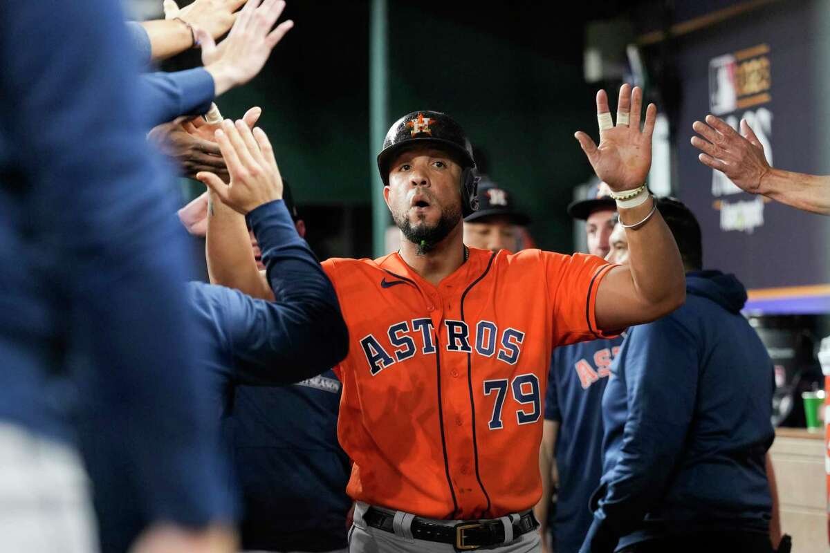 Houston Astros Jose Abreu (79) gets high-fives from teammates after scoring on Mauricio Dubón's RBI single in the fourth inning of Game 3 during the American League Championship Series at Globe Life Field on Wednesday, Oct. 18, 2023, in Arlington.