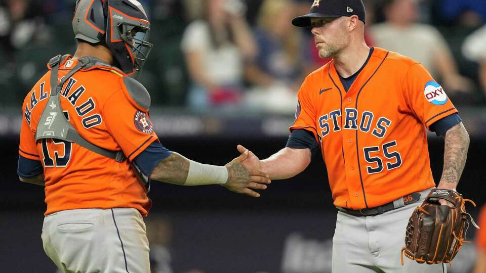 Houston Astros relief pitcher Ryan Pressly, right, celebrates with catcher Martin Maldonado after getting Texas Rangers Josh Jung to ground out into a double play and end the ninth inning of Game 3 during the American League Championship Series at Globe Life Field on Wednesday, Oct. 18, 2023, in Arlington.