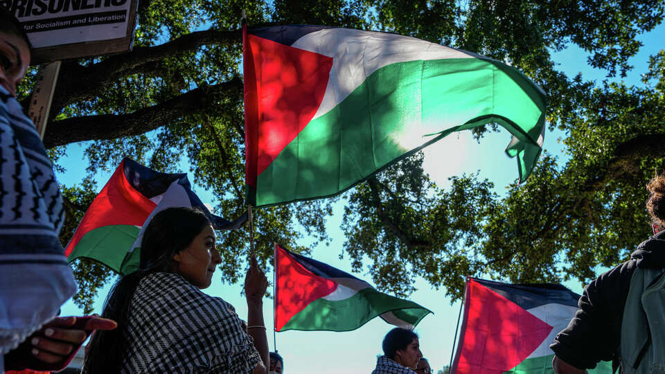 Thousands of people gather outside of the Israeli Embassy to protest Isreal's ongoing attacks on Gaza in the Isreal-Hamas war on Wednesday, Oct. 18, 2023, in Houston.