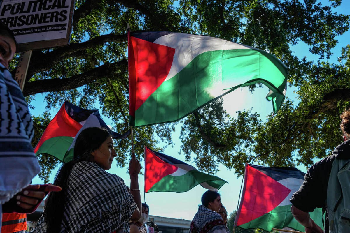 Thousands of people gather outside of the Israeli Embassy to protest Isreal's ongoing attacks on Gaza in the Isreal-Hamas war on Wednesday, Oct. 18, 2023, in Houston.