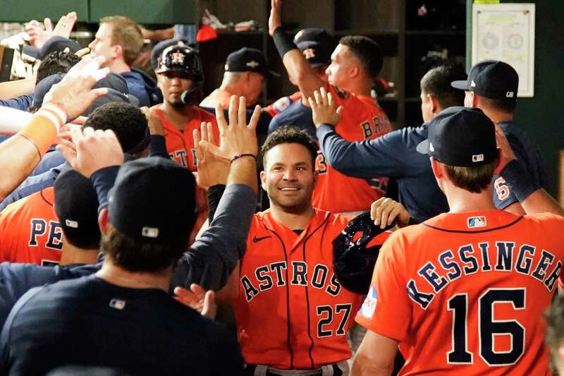 Houston Astros fans hold signs supporting second baseman Jose Altuve (27)  and designated hitter Yordan Alvarez before a baseball game between the  Seattle Mariners and the Astros, Friday, July 22, 2022, in