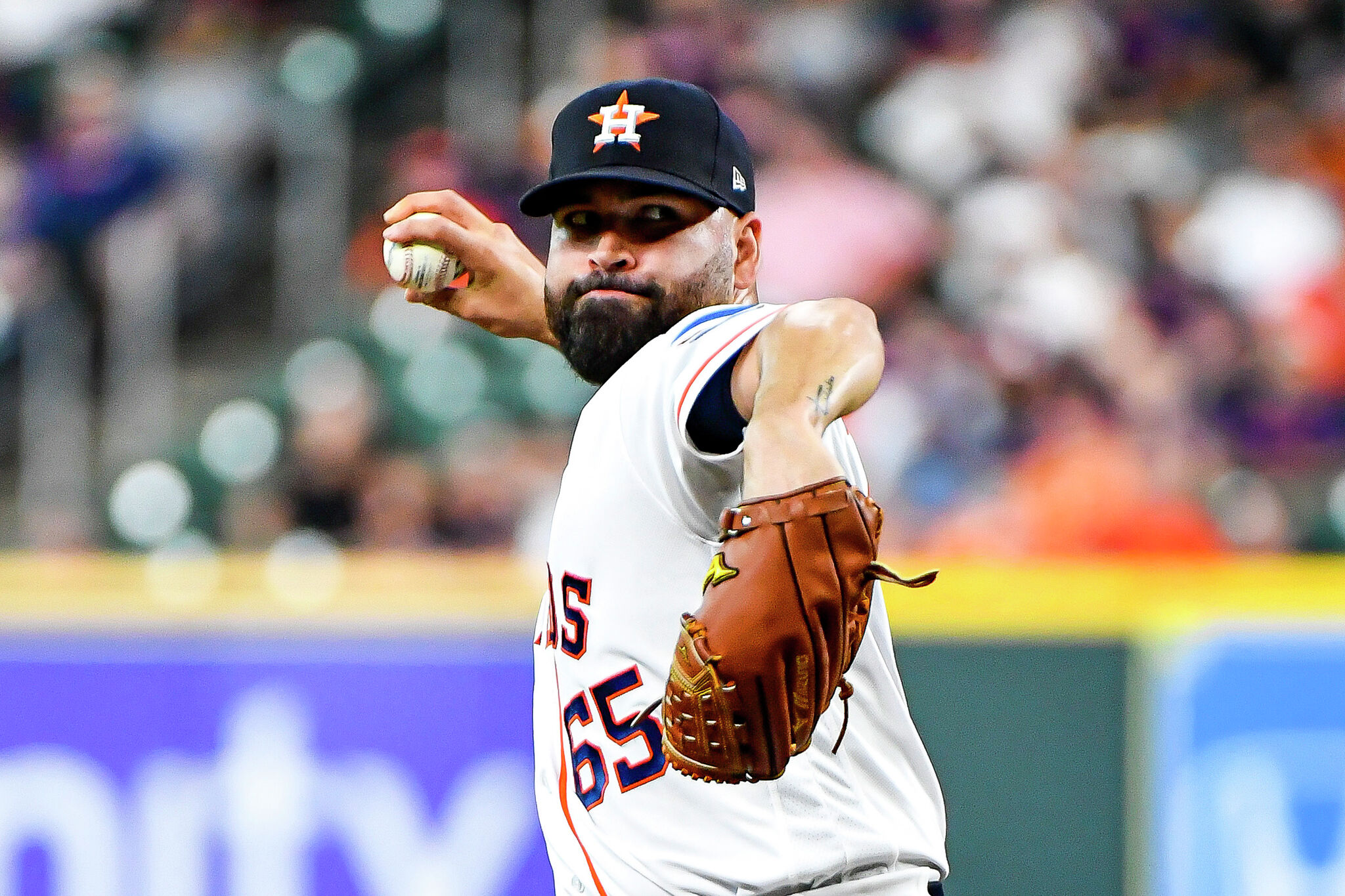 HOUSTON, TX - MAY 22: Houston Astros starting pitcher Jose Urquidy (65)  throws the ball to first base in the top of the first inning during the  baseball game between the Texas