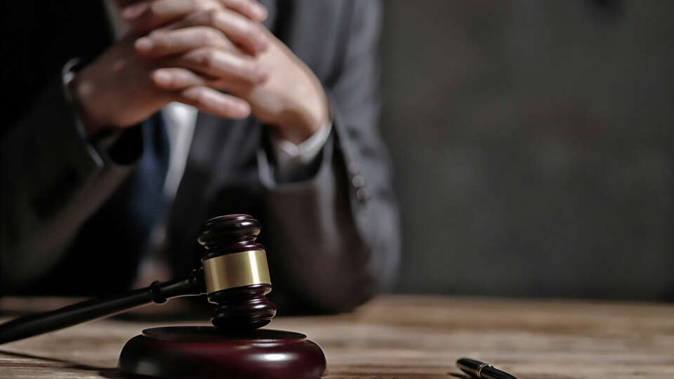 Photo of a judge and his gavel. Thoughtful.