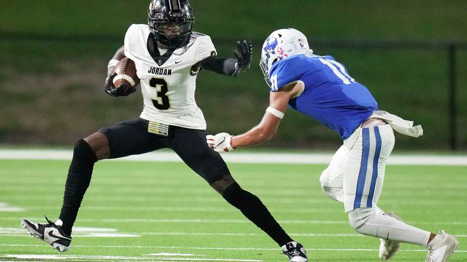 Jordan wide receiver Andrew Marsh (3) fends off Katy Taylor defensive back Solomon Ross during the first half of a high school football game, Thursday, Oct. 19, 2023, in Katy.