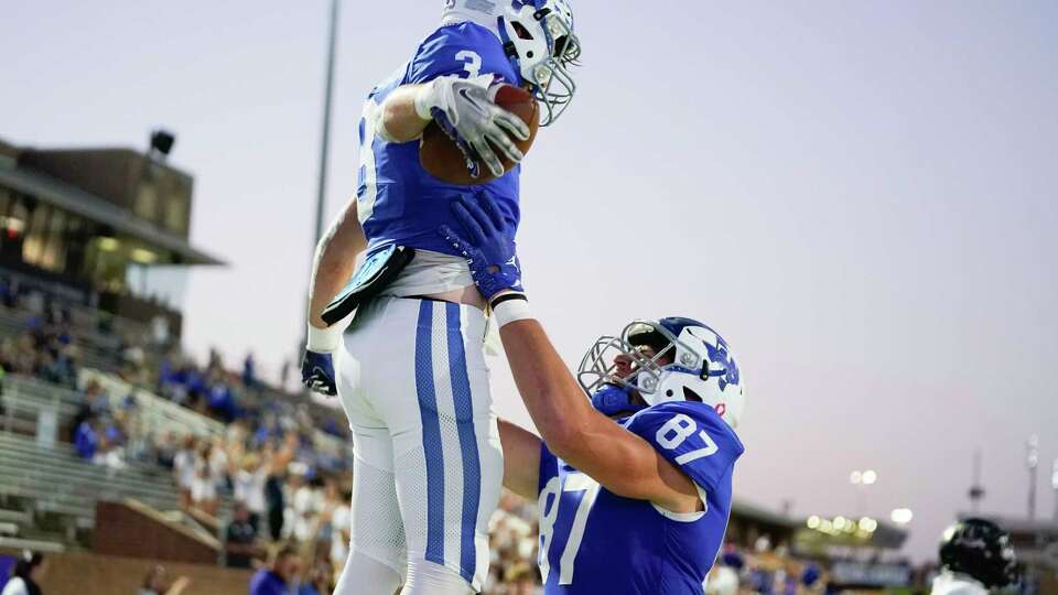 Katy Taylor running back Ethan Jacobson (3) celebrates his touchdown with tight end Ian Flynt during the first half of a high school football game against Jordan, Thursday, Oct. 19, 2023, in Katy.