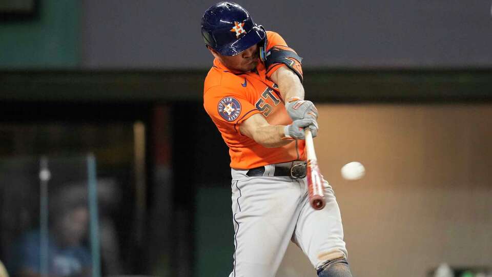 Houston Astros Jose Altuve (27) hits a double in the eighth inning of Game 4 of the American League Championship Series at Globe Life Field on Thursday, Oct. 19, 2023, in Arlington. Altuve's hit was initially a home run, but was overturned to a double after an umpire review.