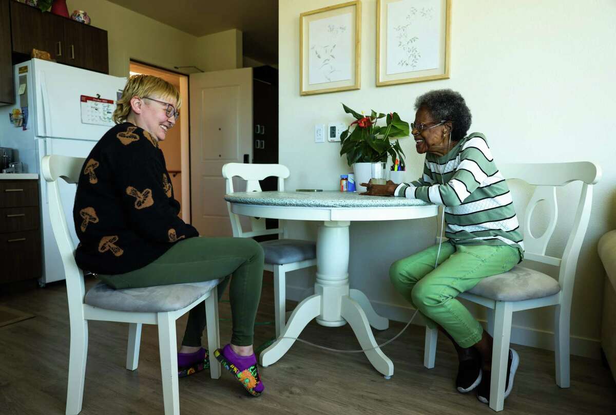 Cassidy White, left, senior site manager, talks with resident Barbara King inside King’s unit at Laurel at Perennial Park in Santa Rosa. King fled her previous home during the Tubbs Fire.