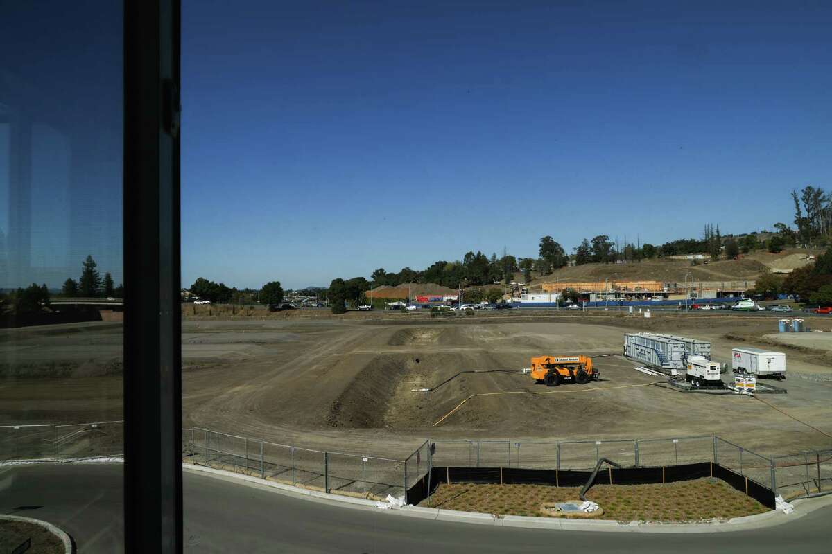 Work for the next housing complex is visible from Barbara King’s third-floor window at Laurel at Perennial Park in Santa Rosa. The city is redeveloping with more dense housing.