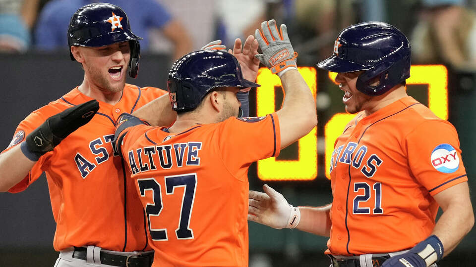 Houston Astros Grae Kessinger, left, and Yainer Diaz, right, celebrate after Jose Altuve's three-run home run to take a 5-4 lead in the ninth inning of Game 5 during the American League Championship Series at Globe Life Field on Friday, Oct. 20, 2023, in Arlington.