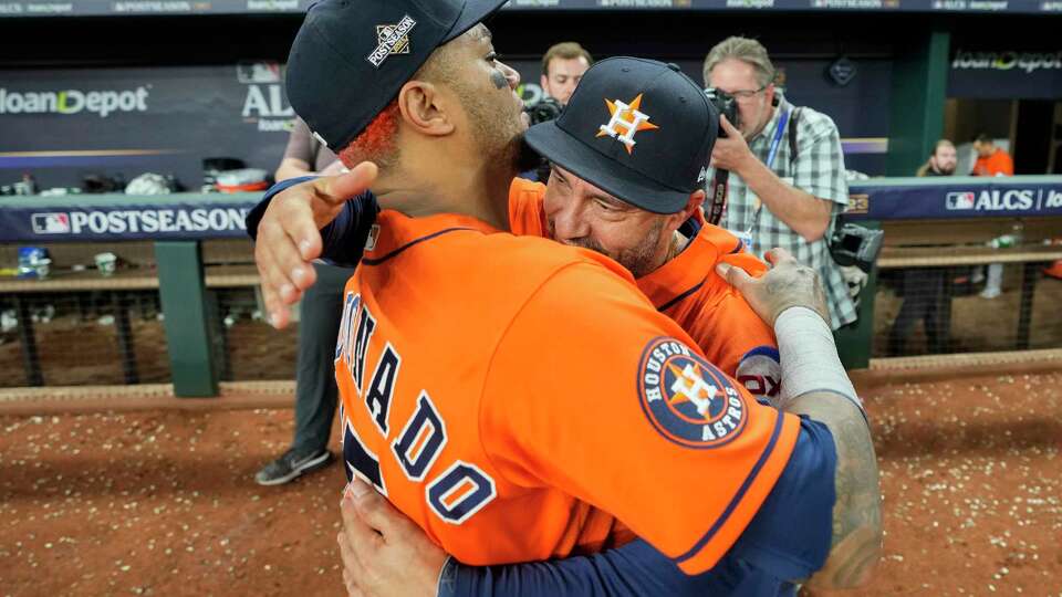 Houston Astros Martin Maldonado, left, hugs bullpen coach Javier Bracamonte after the team's 5-4 win over the Texas Rangers in the ninth inning of Game 5 during the American League Championship Series at Globe Life Field on Friday, Oct. 20, 2023, in Arlington.