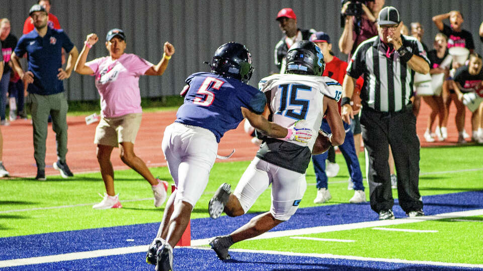 Shadow Creek's Aaden Benjamin (15) steps in front of Dawson's Bryce Burgess (5) to intercept and return 100 yards for a touchdown to defeat Dawson in overtime of a high school football game at The Rig, Friday, Oct. 20, 2023 in Pearland.