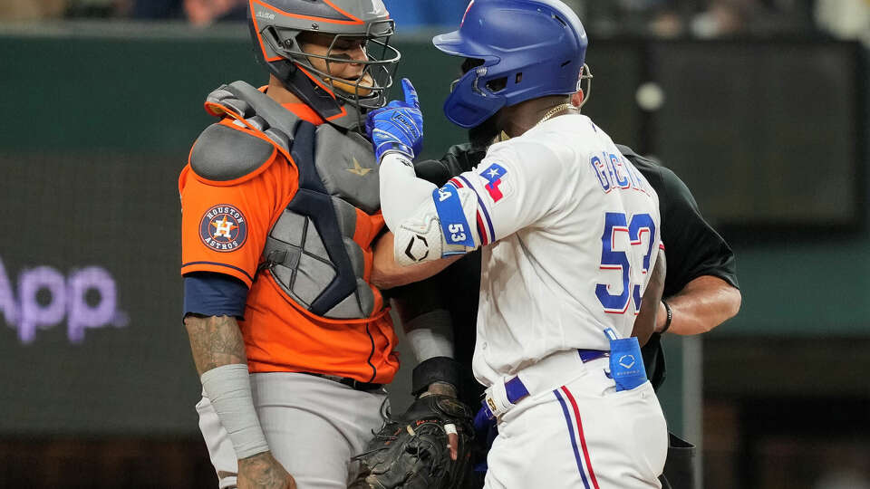 Texas Rangers Adolis Garcia, right, gets in the face of Houston Astros catcher Martin Maldonado after being hit by a pitch from relief pitcher Bryan Abreu, clearing the benches in the eighth of Game 5 during the American League Championship Series at Globe Life Field on Friday, Oct. 20, 2023, in Arlington. Garcia, Abreu and Astros manager Dusty Baker were all ejected from the game.