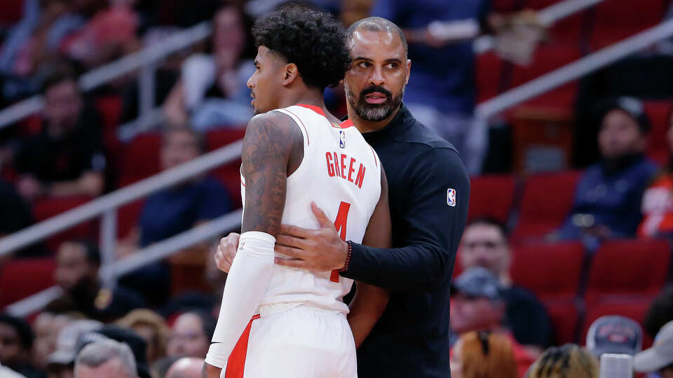 Houston Rockets guard Jalen Green, left, and head coach Ime Udoka, right, talk during a timeout during the first half of a preseason NBA basketball game against the Miami Heat, Friday, Oct. 20, 2023, in Houston. (AP Photo/Michael Wyke)