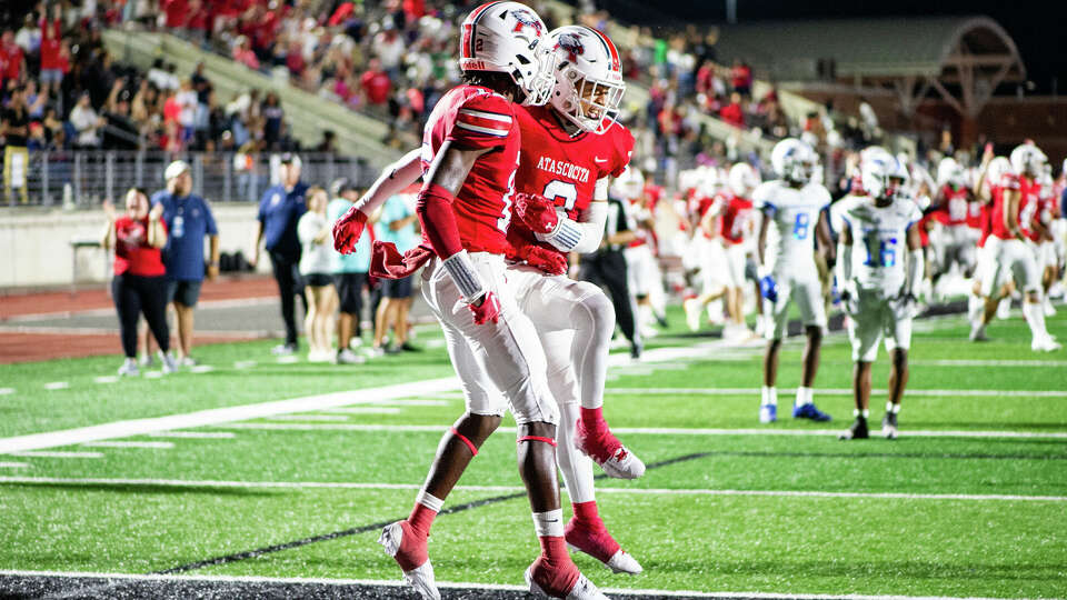 Atascocita's Cameron Glenn (12) and Kyran Pate (3) celebrate defeating C.E. King with a touchdown in overtime of a high school football game at George Turner Stadium, Saturday, Oct. 21, 2023 in Humble.