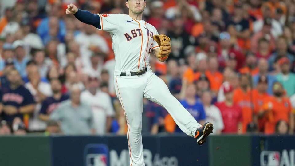 Houston Astros third baseman Alex Bregman (2) throws out Texas Rangers Evan Carter (32) in the second inning during Game 7 of the American League Championship Series at Minute Maid Park on Monday, Oct. 23, 2023, in Houston.