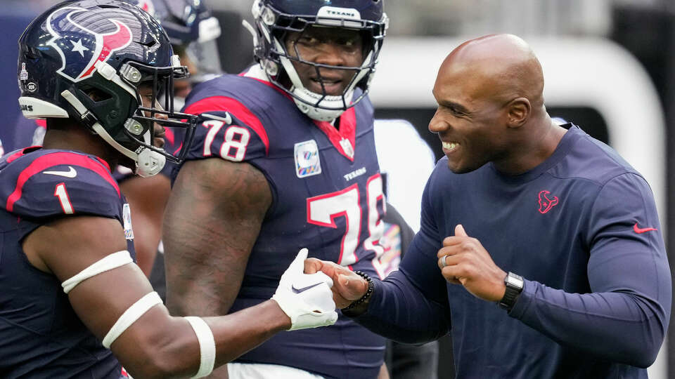 Houston Texans head coach DeMeco Ryans, right, greets safety Jimmie Ward (1) before an NFL football game Sunday, Oct. 15, 2023, in Houston.