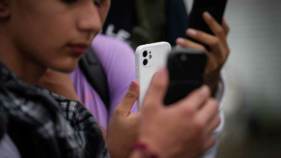 Students record with their cell phones during a protest Thursday, Oct. 26, 2023, near Eastwood Academy in Houston.