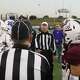 Midland High and Legacy team captains meet midfield for the coin toss before their Oct. 27 football game at Astound Broadband Stadium. 
