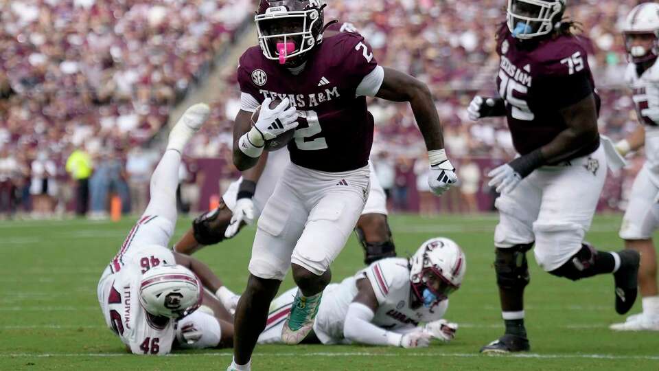 Texas A&M running back Rueben Owens (2) breaks free from South Carolina defenders for a touchdown run during the second quarter of an NCAA college football game Saturday, Oct. 28, 2023, in College Station, Texas. (AP Photo/Sam Craft)