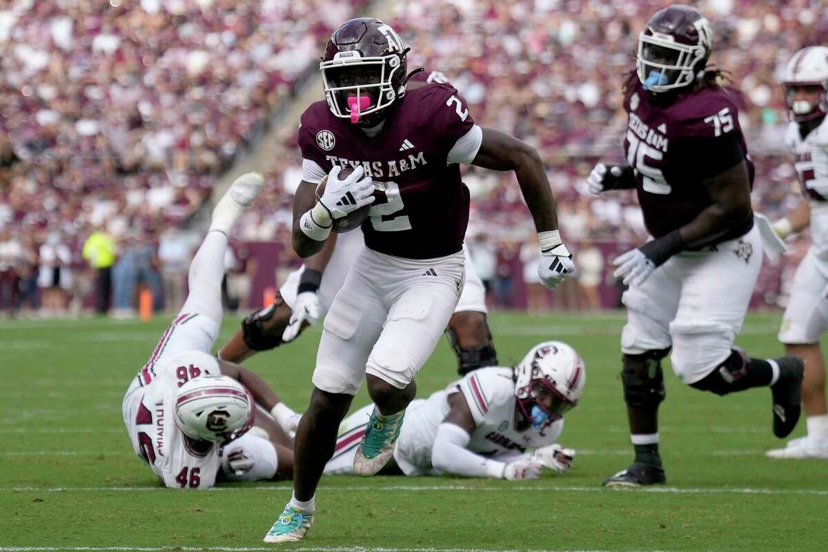 Texas A&M running back Rueben Owens (2) breaks free from South Carolina defenders for a touchdown run during the second quarter of an NCAA college football game Saturday, Oct. 28, 2023, in College Station, Texas. (AP Photo/Sam Craft)