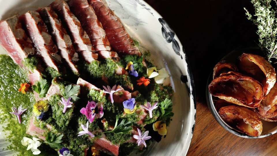 Chef Peter Hemsley’s bar menu special 24 oz. Blue Fin tuna steak, x 10 day dray age, Monterey, Calif., Fisherman, Tuk Yi is seen at Aphotic on Friday, October 27, 2023 in San Francisco, Calif. ,