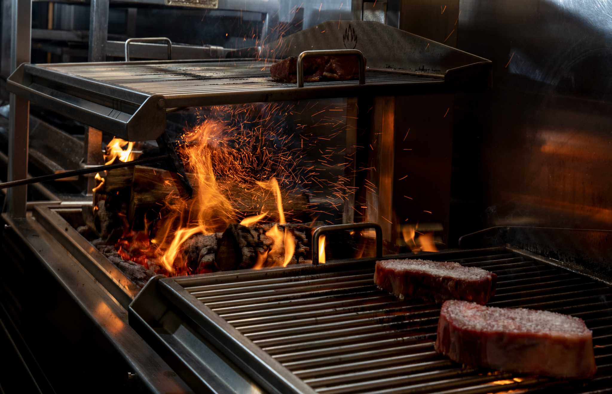 Fancy restaurants in Houston are using live fire barbecue techniques