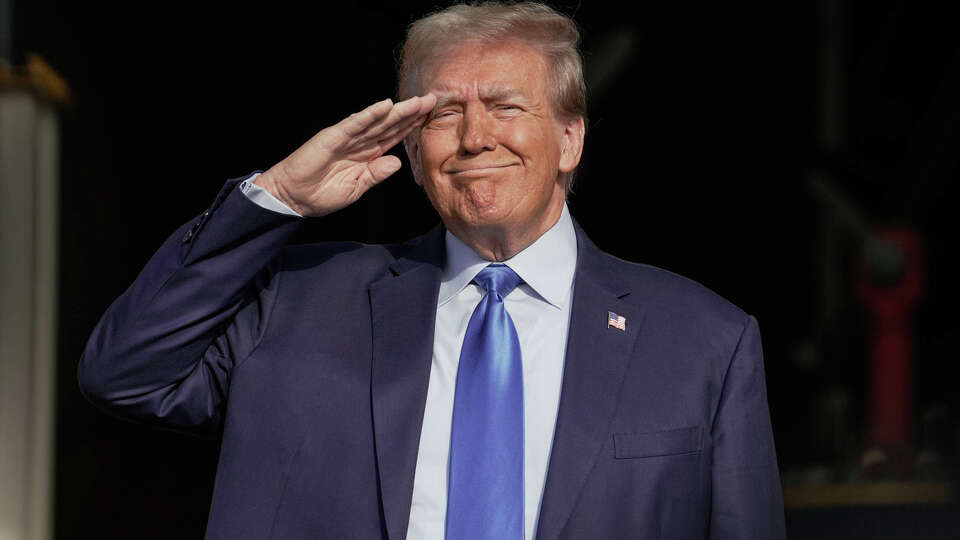 Former President Donald Trump salutes during the pledge of allegiance as he makes a campaign stop on Thursday, Nov. 2, 2023, in Houston.