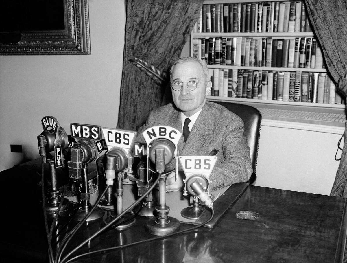 President Harry S. Truman talks in front of microphones over which he broadcast a message from the White House in Washington opening the conference of 46 nations in San Francisco on April 25, 1945.