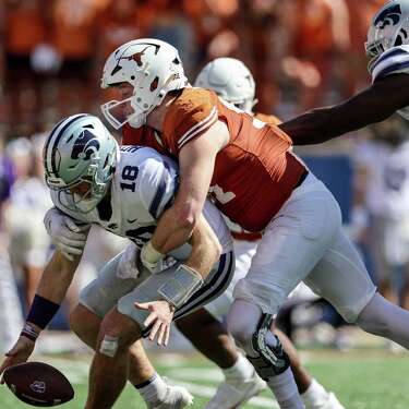 AUSTIN, TEXAS - NOVEMBER 04: Ethan Burke #91 of the Texas Longhorns sacks Will Howard #18 of the Kansas State Wildcats forcing a fumble in the third quarter at Darrell K Royal-Texas Memorial Stadium on November 04, 2023 in Austin, Texas.