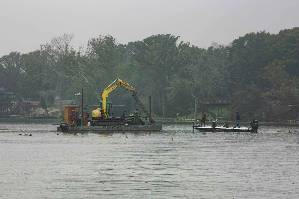 Volunteers help clean up debris that accumulated in Lake Dunlap while it remained empty over the past four years.