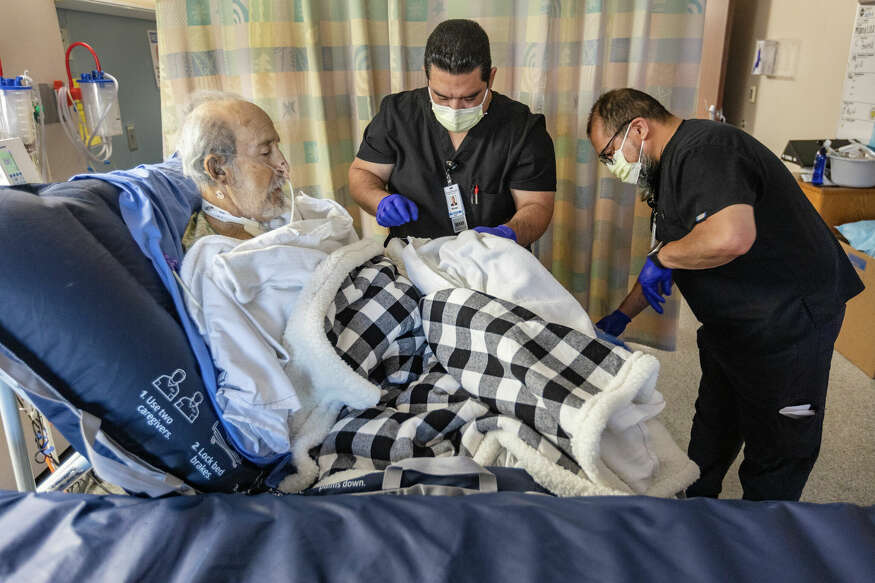 Kindred Hospital physical therapists work Tuesday, Oct. 17, 2023, with Max de Los Santos in his hospital room. De Los Santos lost both his legs after an August 2023 dog attack and continues to recover at the hospital.