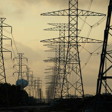 The sun rises over power lines Tuesday, June 27, 2023, in Houston. Meteorologists say scorching temperatures brought on by a heat dome have taxed the Texas power grid and threaten to bring record highs to the state. (AP Photo/David J. Phillip)