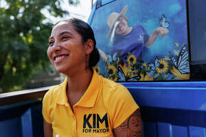 Uvalde mayoral candidate Kimberly Mata-Rubio rides in the back of her family’s pick up truck after walking in Uvalde’s Labor Day Weekend parade on Saturday, Sept. 2, 2023, in Uvalde, Texas. The truck wrapped with pictures of her daughter Lexi Rubio, one of the 19 children killed in the Robb Elementary massacre on May 24, 2022.