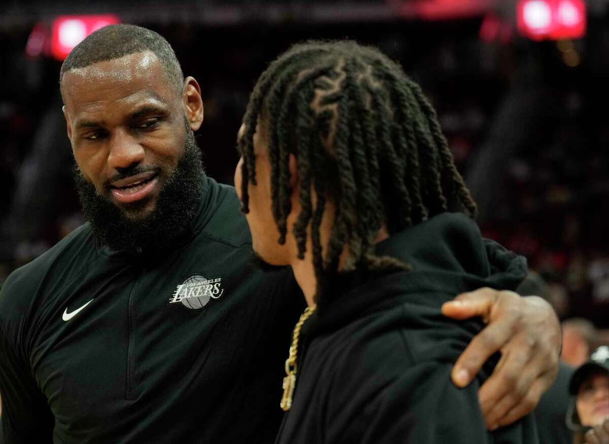 Lakers forward LeBron James (left) visits with Texans quarterback C.J. Stroud before Wednesday's game. This was their first face-to-face meeting.