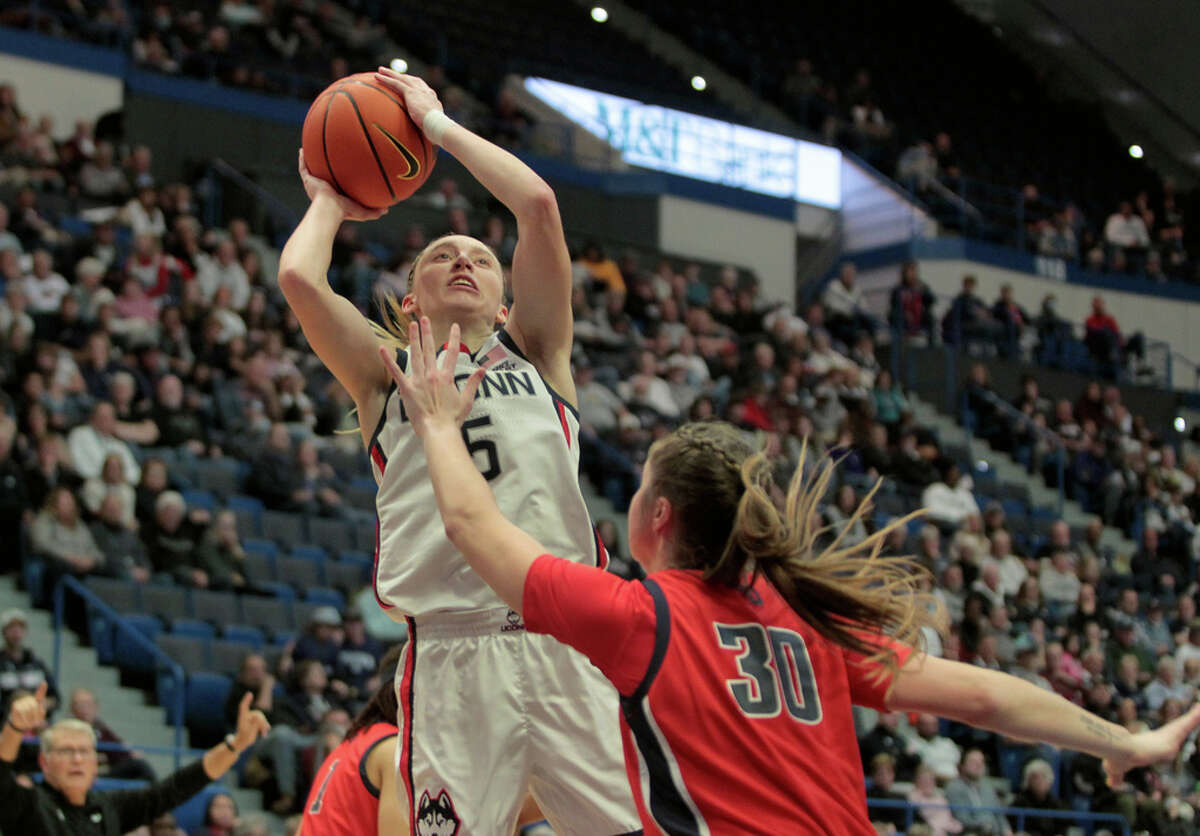 UConn's Paige Bueckers (5) attempts a shot as Dayton's Riley Rismiller (30) defends during women's college basketball action at the XL Center Arena in Hartford, Conn., on Wednesday November 8, 2023.