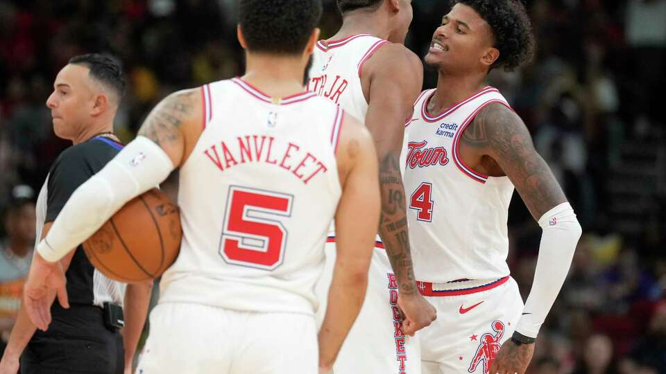 Houston Rockets guard Jalen Green, right, celebrates with forward Jabari Smith Jr. after dunking the ball during the first half on an NBA basketball game, Wednesday, Nov. 8, 2023, in Houston.