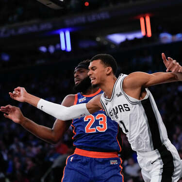 San Antonio Spurs' Victor Wembanyama, right, and New York Knicks' Mitchell Robinson fight for a rebound during the first half of an NBA basketball game, Wednesday, Nov. 8, 2023, in New York. (AP Photo/Seth Wenig)