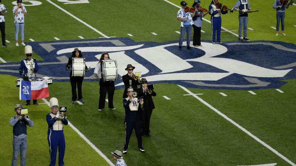 Past and present members of the Rice Marching Owl Band perform for fans before an NCAA college football game between Rice and SMU at Rice Stadium, Saturday, Nov. 4, 2023, in Houston.