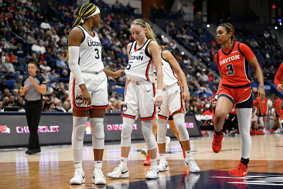 UConn forward Aaliyah Edwards (3) tugs on the shirt of teammate Paige Bueckers (5) in the second half of an NCAA college basketball game against Dayton, Wednesday, Nov. 8, 2023, in Hartford, Conn. (AP Photo/Jessica Hill)